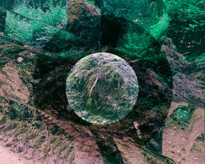 a dug up heap of earth at the roadside in front of green hedge, rounded off