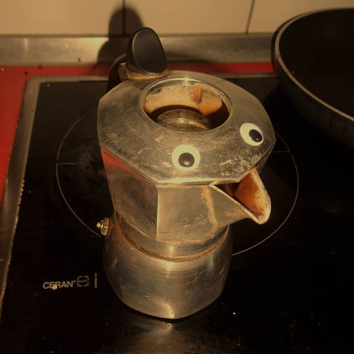 a bialetti mokka machine with eyes