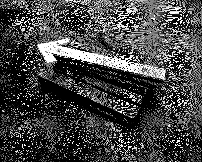 left arrow an arrow made of concrete pointing to the left. On a wooden palette in construction mud