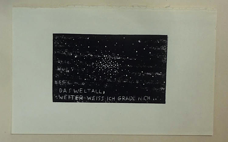 rather small black lino print on an old torn out book page. some picture of a universe, white star dots and space nebula. the title is hand carved into black space and could be translated as “The universe, that's all I know...”