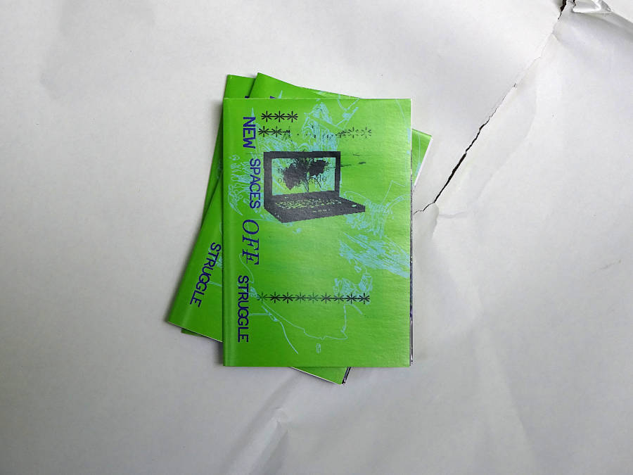 folded poster is a zine in postcard format. green cover with a black smeared laptop drawing and purple glitch.